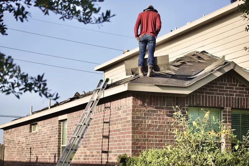 Professional roofer working on a residential roof in Westside Perris